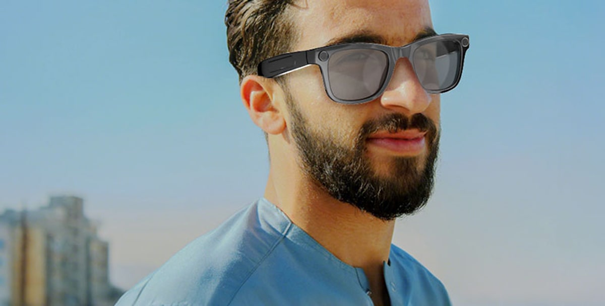 Model wearing AG18 AI glasses in an outdoor lifestyle scene